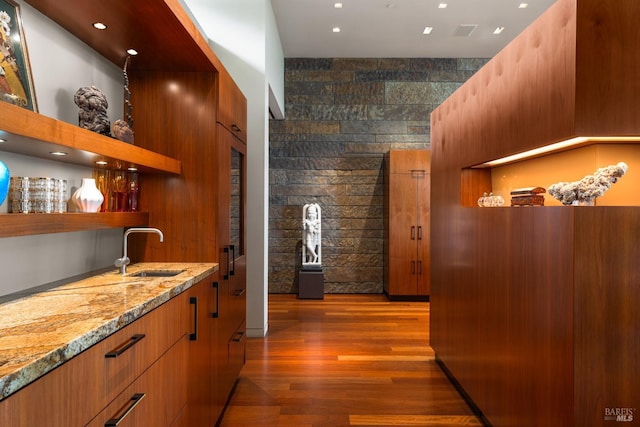 hall with recessed lighting, wood finished floors, and a sink