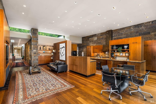 interior space featuring a high ceiling and wood finished floors