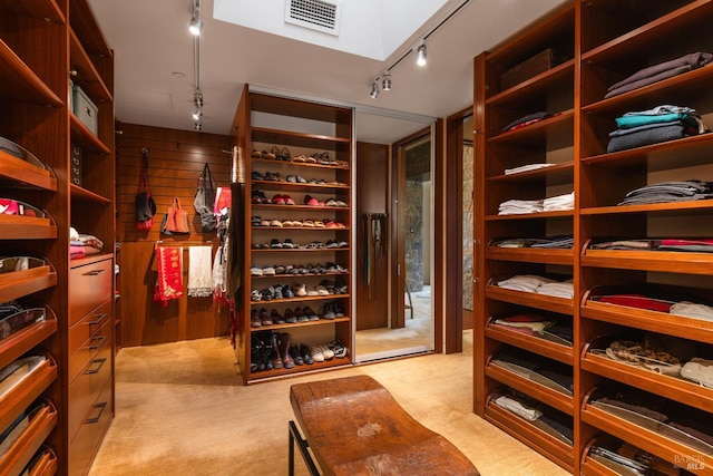 walk in closet featuring visible vents and light colored carpet