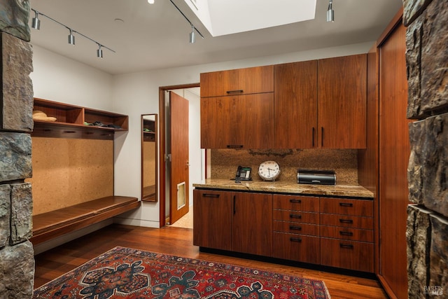 kitchen featuring track lighting, open shelves, dark wood-style floors, and a skylight