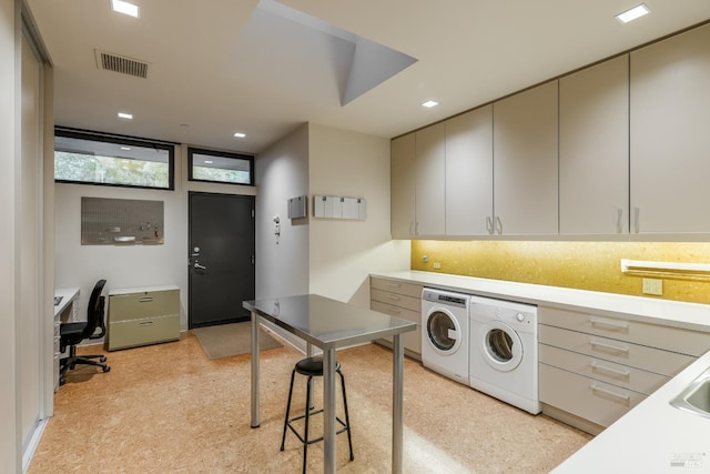 laundry room featuring visible vents, washer and clothes dryer, and cabinet space