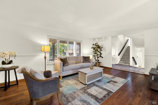 living area featuring stairway, baseboards, and wood-type flooring