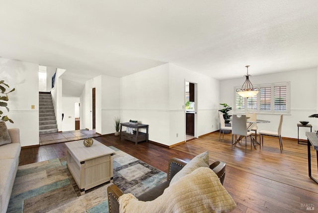 living area with hardwood / wood-style floors, stairway, and baseboards