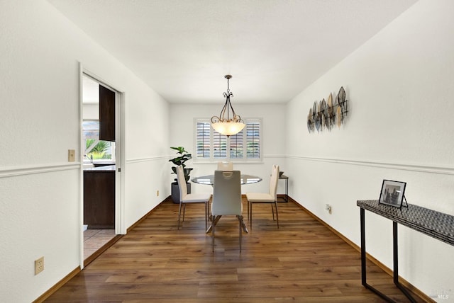 dining space with wood finished floors