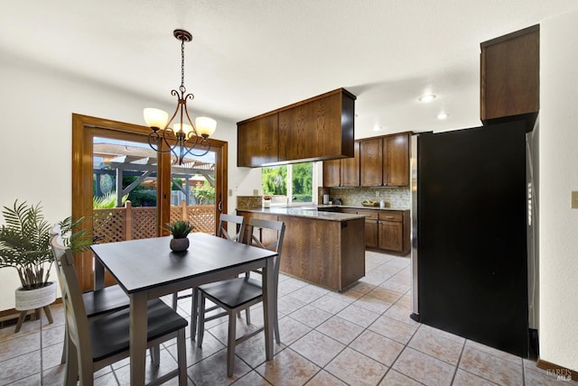 kitchen featuring recessed lighting, a chandelier, light tile patterned flooring, tasteful backsplash, and decorative light fixtures