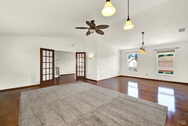 unfurnished living room with a ceiling fan, dark wood-style flooring, lofted ceiling, and visible vents