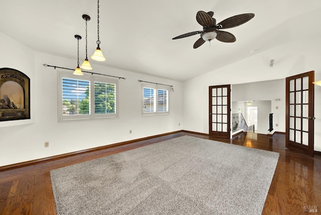 unfurnished living room with vaulted ceiling, french doors, and dark wood-style floors