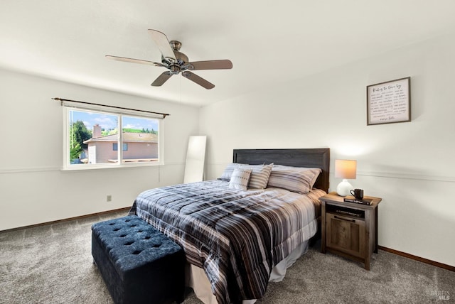 carpeted bedroom with ceiling fan and baseboards