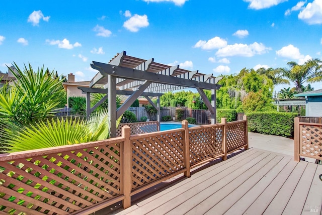wooden deck with fence, a pergola, and a fenced in pool