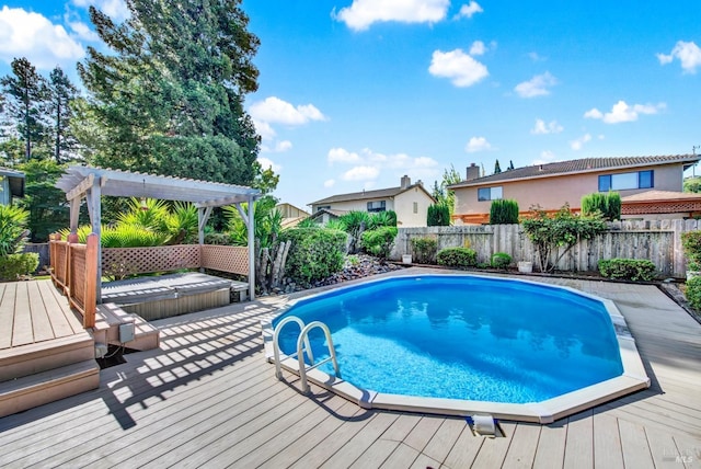 view of swimming pool featuring a fenced in pool, a pergola, a wooden deck, and a fenced backyard