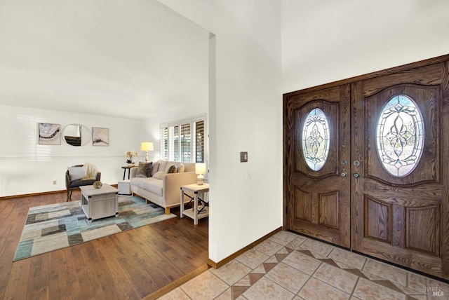 foyer featuring baseboards and light wood-style flooring