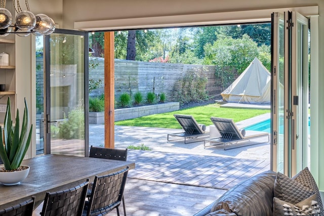 doorway to outside featuring an inviting chandelier and a healthy amount of sunlight