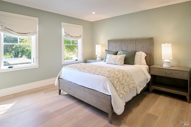 bedroom with light wood-type flooring, recessed lighting, and baseboards