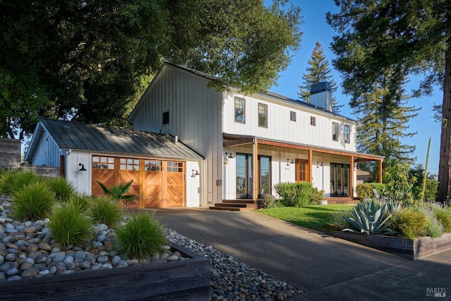 view of front of home with board and batten siding, aphalt driveway, and an attached garage