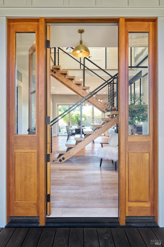 doorway featuring hardwood / wood-style flooring and stairs