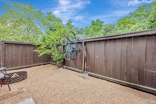 view of yard with a fire pit and fence