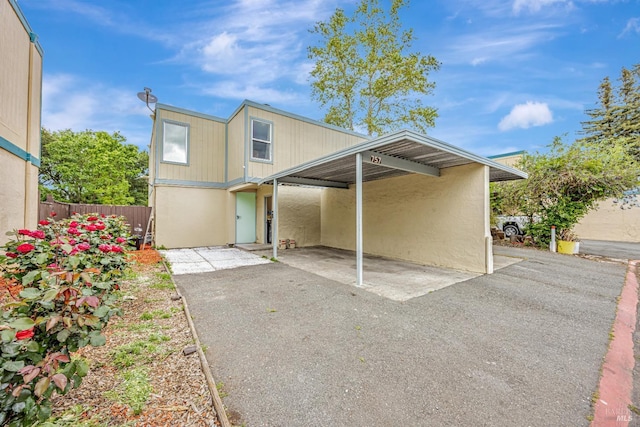 view of front of house featuring fence and stucco siding