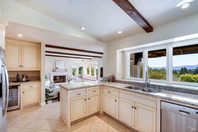 kitchen featuring beverage cooler, light stone counters, stainless steel appliances, a sink, and light tile patterned flooring