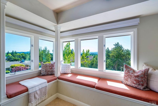 living area with baseboards and light tile patterned floors