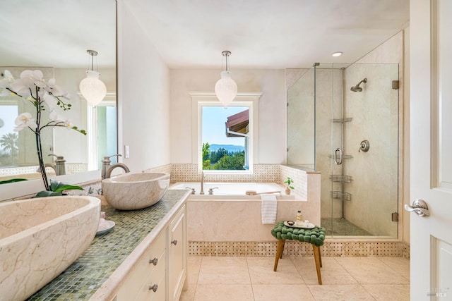 full bath featuring a sink, a shower stall, a bath, tile patterned floors, and double vanity