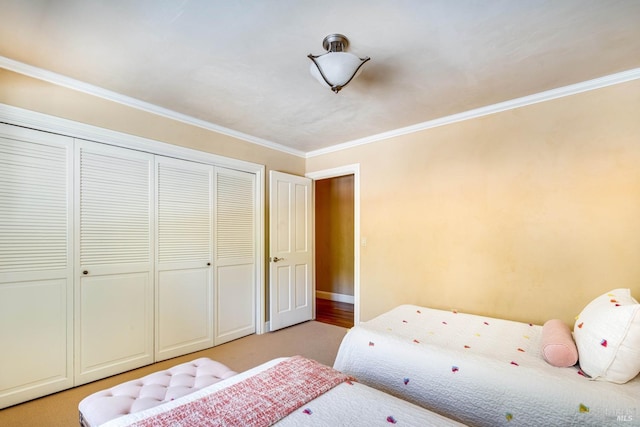 bedroom featuring ornamental molding, light carpet, and a closet