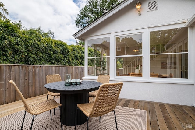 wooden deck featuring outdoor dining space