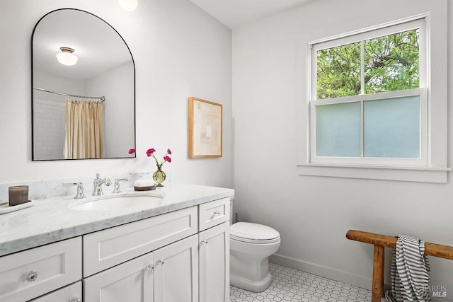 bathroom featuring baseboards, a shower with shower curtain, toilet, and vanity