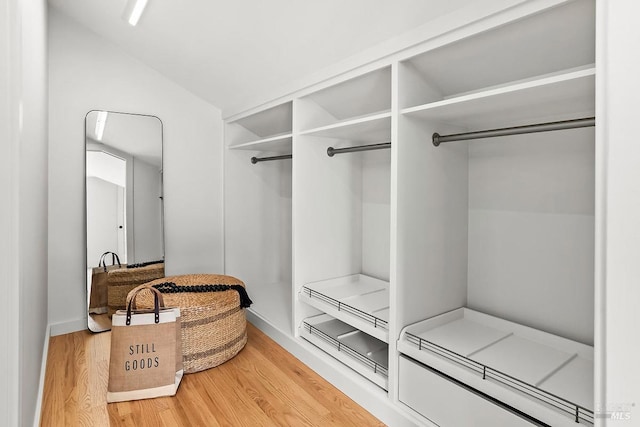 mudroom with light wood-style flooring and lofted ceiling