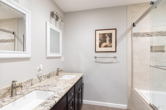 bathroom featuring tiled shower / bath combo, baseboards, a sink, and tile patterned floors