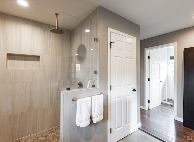 full bathroom featuring recessed lighting, baseboards, a walk in shower, and wood finished floors