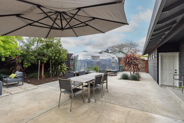 view of patio featuring outdoor dining area and a fenced backyard