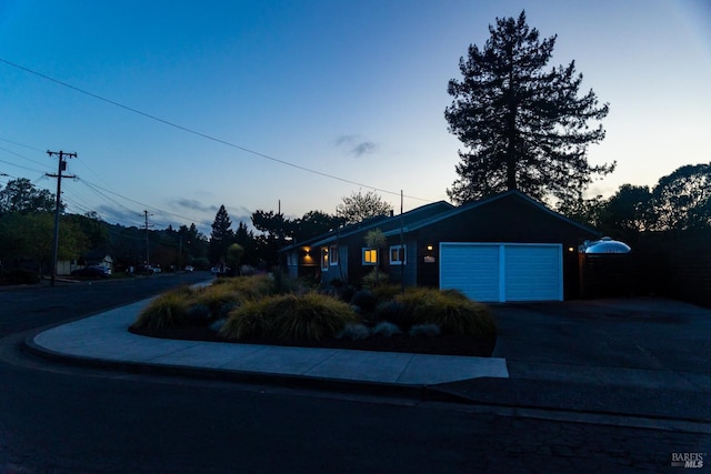 ranch-style home with an attached garage and concrete driveway