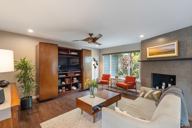 living area with recessed lighting, baseboards, a fireplace, and hardwood / wood-style flooring