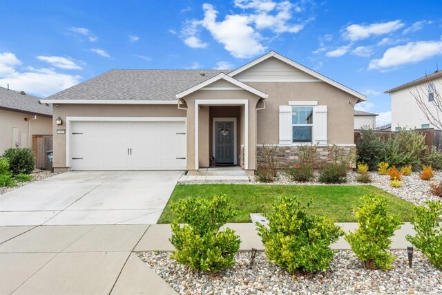 view of front of house featuring a garage, fence, concrete driveway, stone siding, and stucco siding