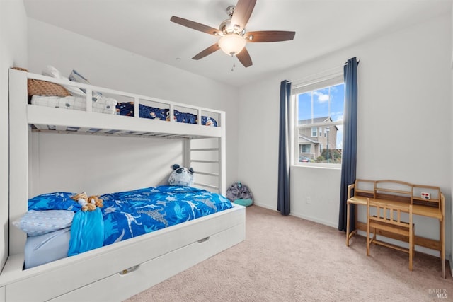 carpeted bedroom with baseboards and ceiling fan