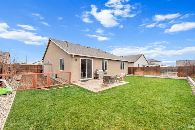 rear view of property with a fenced backyard, a patio, stucco siding, and a yard
