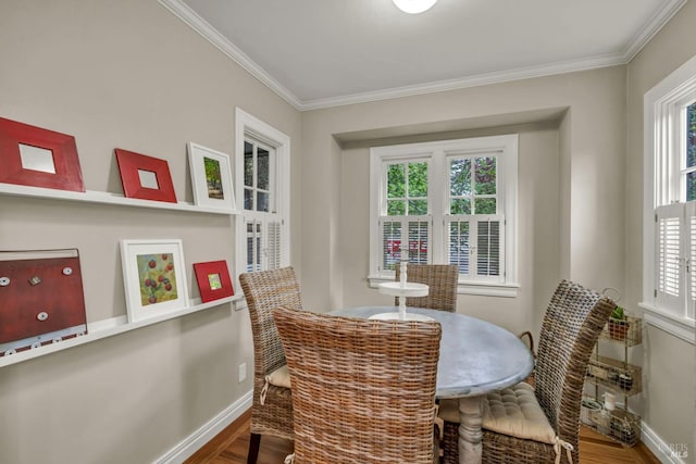 dining area with crown molding, plenty of natural light, wood finished floors, and baseboards