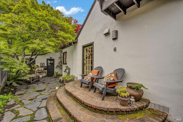 view of patio / terrace with fence and visible vents
