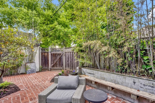 view of patio featuring a gate and fence