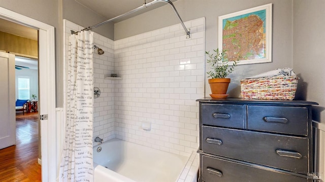 bathroom with wood finished floors and shower / bath combination with curtain