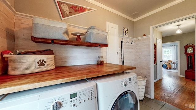 clothes washing area with tile patterned floors, ornamental molding, laundry area, and independent washer and dryer