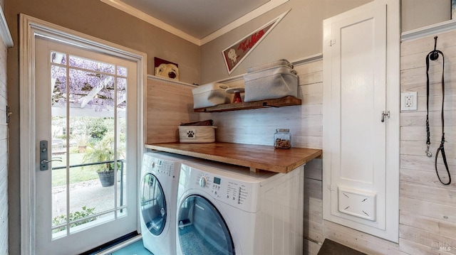 clothes washing area with ornamental molding, washer and dryer, laundry area, and plenty of natural light