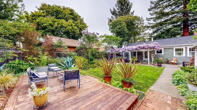 wooden deck with a lawn and fence private yard