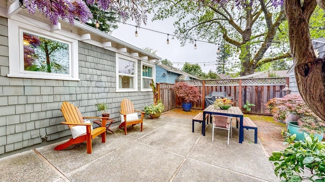 view of patio with a fenced backyard and outdoor dining area