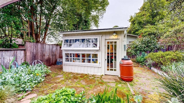 view of outbuilding featuring a fenced backyard and an outbuilding
