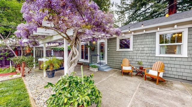 rear view of property featuring a patio and fence