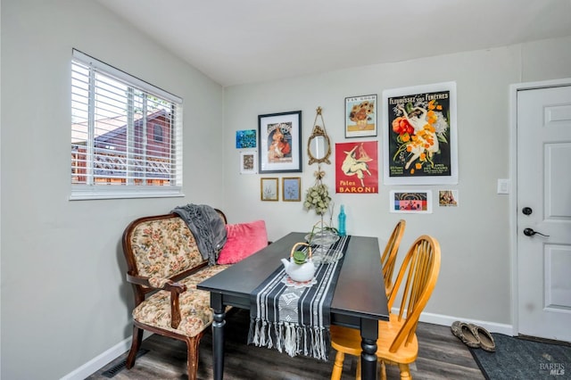 dining room featuring baseboards and wood finished floors