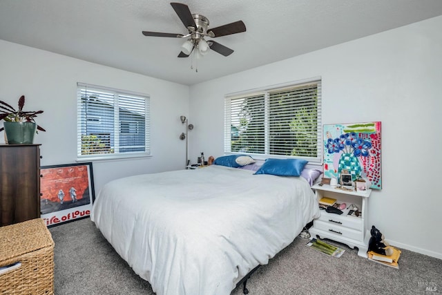 carpeted bedroom with baseboards and a ceiling fan