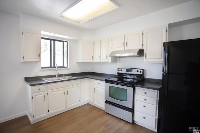 315 Baker St, Petaluma, CA 94952 - kitchen with freestanding refrigerator, under cabinet range hood, stainless steel electric range oven, a sink, and dark countertops