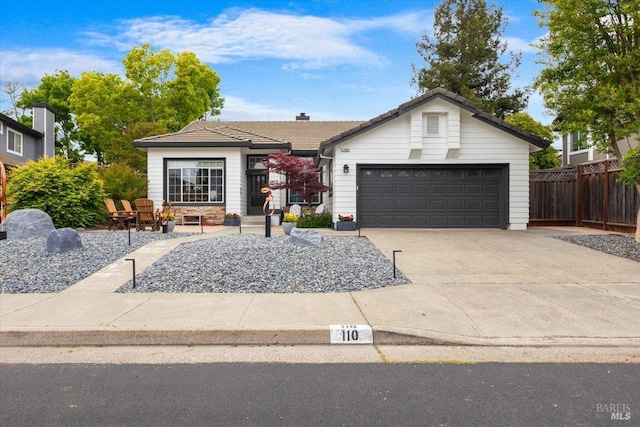 ranch-style home featuring an attached garage, fence, a tile roof, and concrete driveway